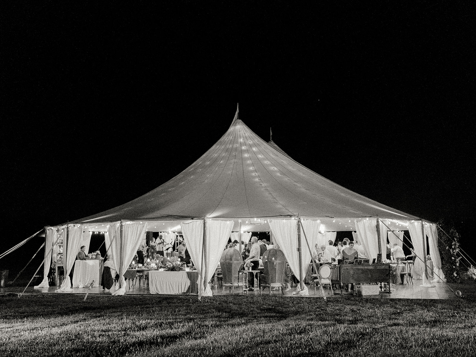 Black and white photo of a sailcloth tent at a Goodstone Inn Wedding by K Bella Events