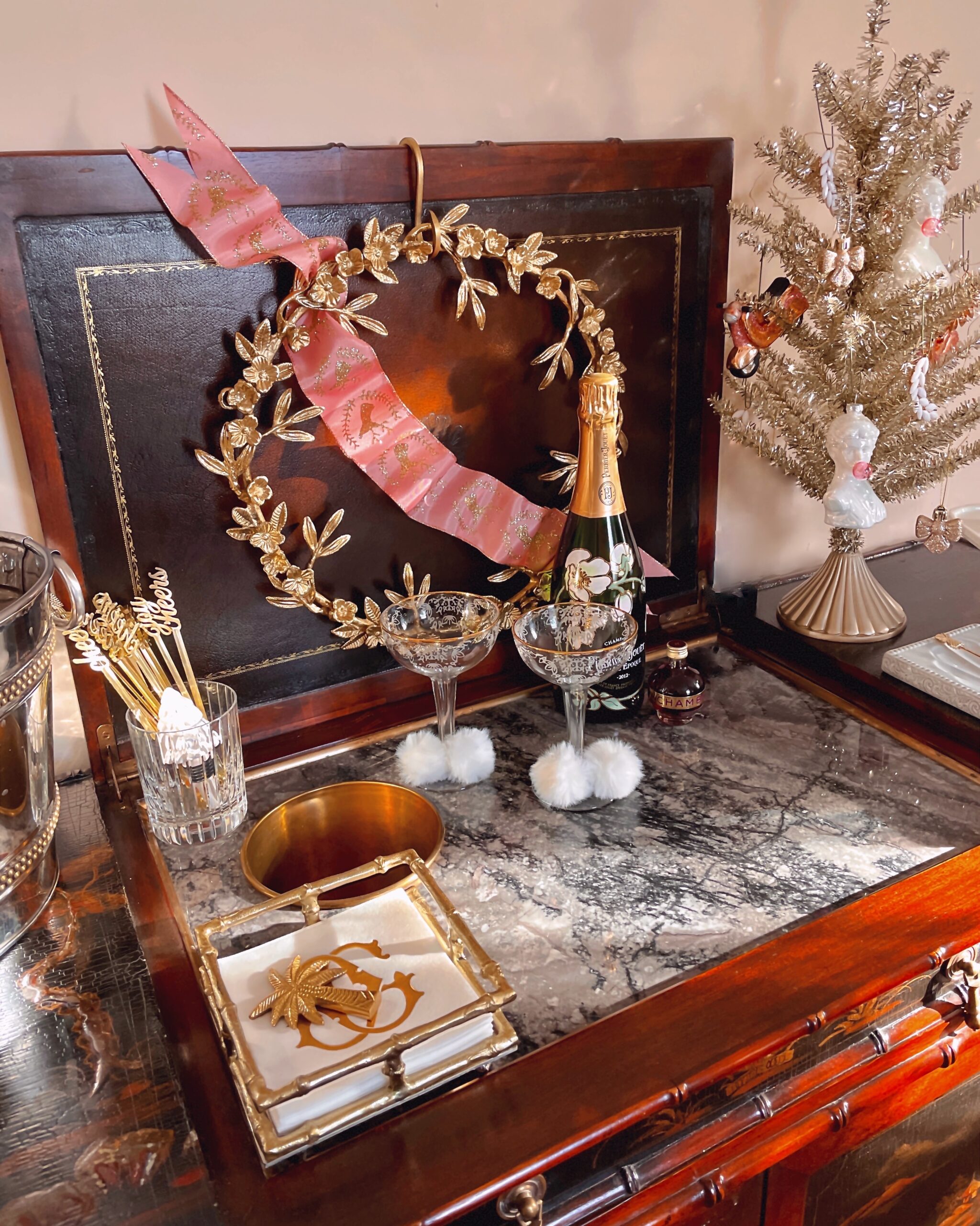 Photo of a home bar decorated with a gold wreath and christmas tree